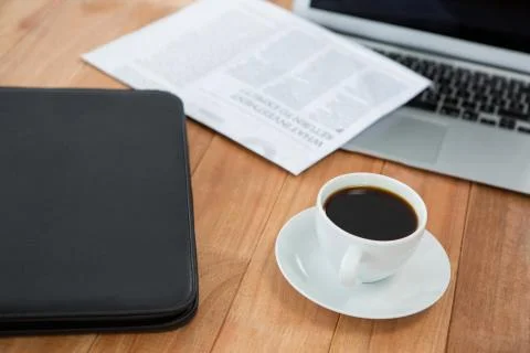 Coffee cup with file folder and laptop Stock Photos