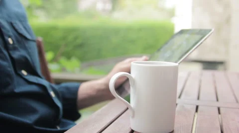 Coffee cup in front of tablet Stock Footage 40665996