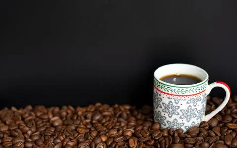Coffee cup full of black coffee with fresh roasted coffee beans Stock Photos