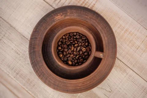 Coffee cup full of coffee beans. Stock Photos