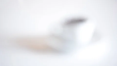 Coffee cup full of roasted coffee beans and white background focusing Video stock 95397178