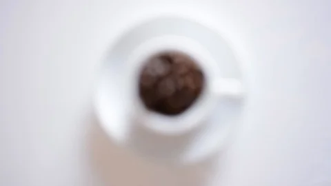 Coffee cup full of roasted coffee beans and white background focusing Video stock 95397185