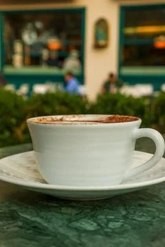 Coffee cup on green marble table enjoying Parisian cafe atmosphere 写真素材
