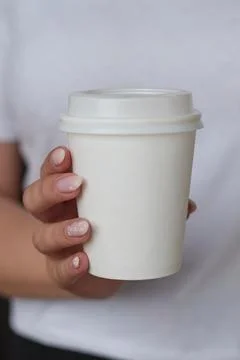 Coffee cup in hand, mockup, custom design, close-up Stock Photos