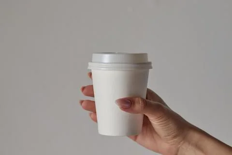 Coffee cup in hand, mockup, custom design, close-up Stock Photos