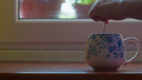 Coffee cup hand stirring spoon static shot Stock Footage 342651767