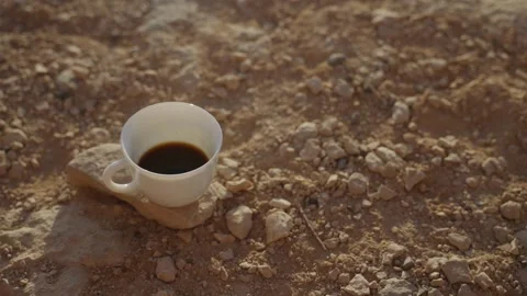 Coffee cup with hot steaming black coffee in desert group during camping Stock Footage 316068959