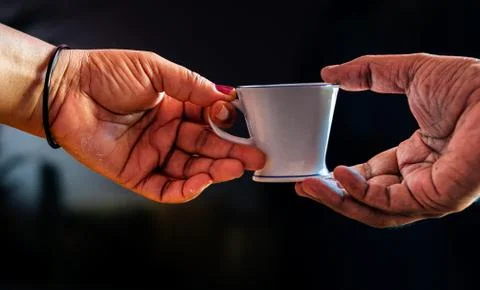 Coffee cup with human hands Stock Photos