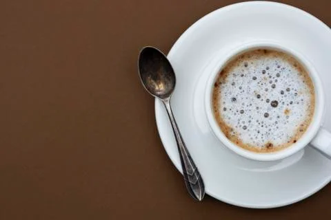 Coffee cup isolated on brown table. Top view, flat lay black coffee drink wit Stock Photos