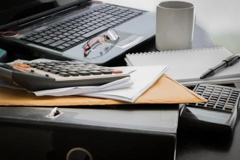 Coffee cup, laptop, document file , pen , calculator , notepad and glasses on Stock Photos