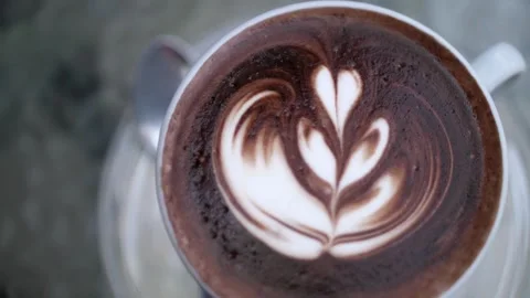 Coffee cup with Latte art, close top video. Cup of coffee with latte art. 動画素材 334650692