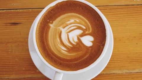 Coffee cup with Latte art, close top video. Cup of coffee with latte art. 動画素材 334650700