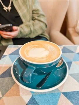 Coffee Cup with Latte Art on a Table Stock Photos