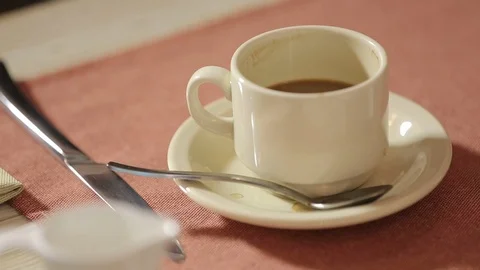 Coffee cup left on the table, no visitors in the cafe Stock Footage 126767938