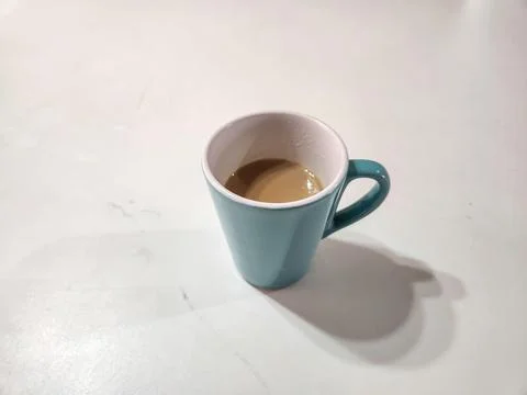 Coffee cup on a light table. Stock Photos