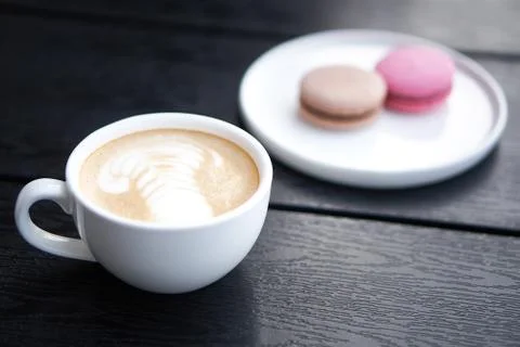 Coffee cup with macaroons Stock Photos