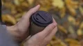 Coffee cup in man hands, male feeling lonely and sad in the park, break up HD Footage