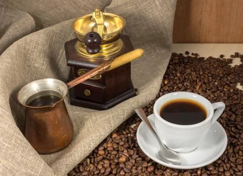 Coffee in a cup on a marble table, hand-mill and cezve Foto stock