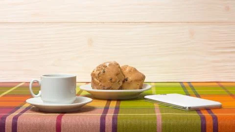Coffee Cup muffins smartphone on the table Stock Photos