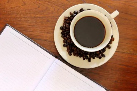 Coffee cup with note book Stock Photos