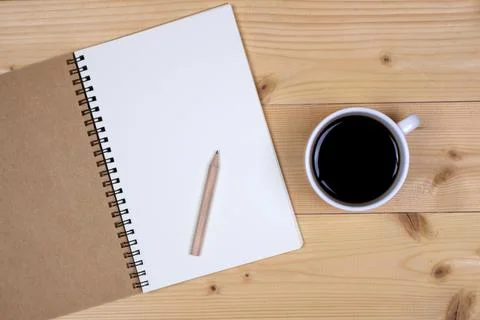 Coffee cup with note book on table Stock Photos