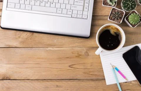 Coffee cup with notebook computer and mobile phone have copy space on a woode Stock Photos