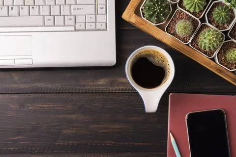 Coffee cup with notebook computer and mobile phone have copy space on a woode Stock Photos