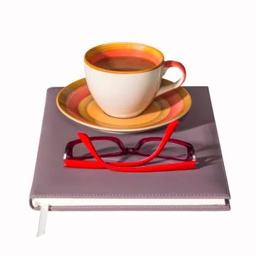 Coffee cup on notebook Stock Photos