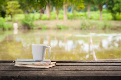 Coffee cup with notebook on rustic wood table Stock Photos