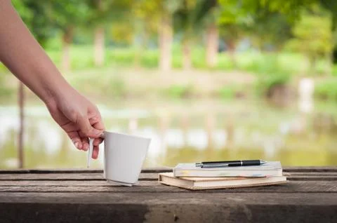 Coffee cup with notebook on rustic wood table Stock Photos