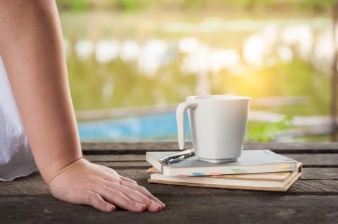Coffee cup with notebook on rustic wood table Stock Photos