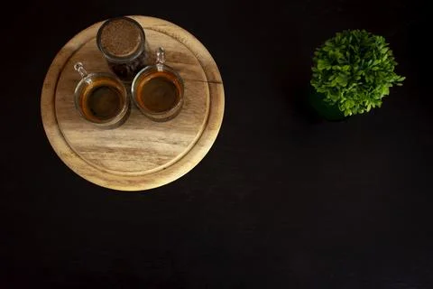 Coffee cup with ornamental tree in the upper corner of the image. Stock Photos