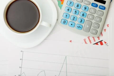 Coffee cup over financial documents Stockfoto's