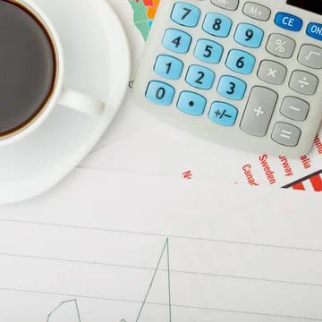 Coffee cup over financial documents Coffee cup over financial documents Co... Stockfoto's