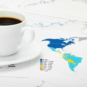 Coffee cup over world map and financial documents Stockfoto's