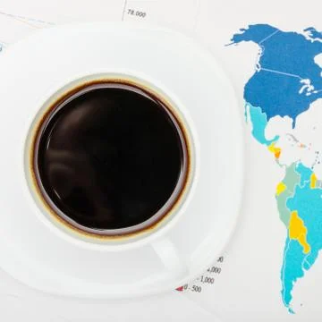 Coffee cup over world map and financial documents - view from top Stockfoto's