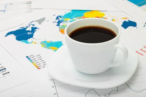  Coffee cup over world map and some financial documents Coffee cup over wo... Foto stock