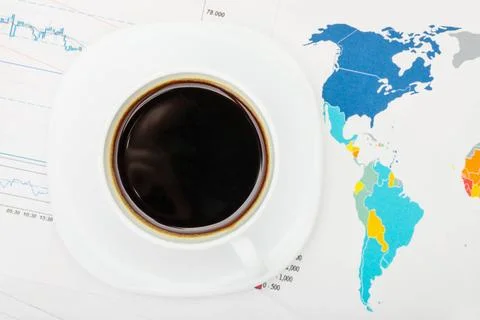  Coffee cup over world map and financial documents - view from top Coffee ... 写真素材