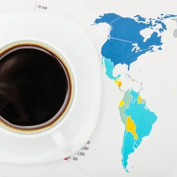  Coffee cup over world map and financial documents - view from top Coffee ... 스톡 사진