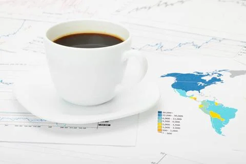  Coffee cup over world map and financial documents Coffee cup over world m... 写真素材