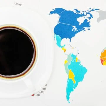 Coffee cup over world map and financial documents - view from top Coffee c... Fotos Stock