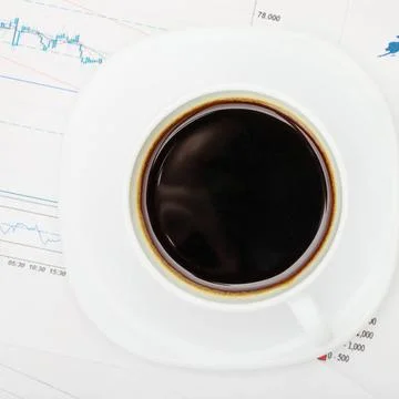 Coffee cup over world map and financial documents - view from top Coffee c... Stockfoto's