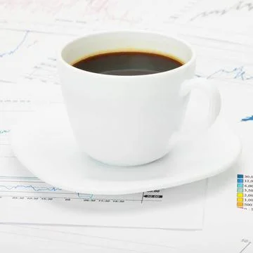Coffee cup over world map and financial documents Coffee cup over world ma... 写真素材