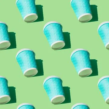 Coffee cup pattern on green background. Textured turquoise paper cups with wh Stock Photos