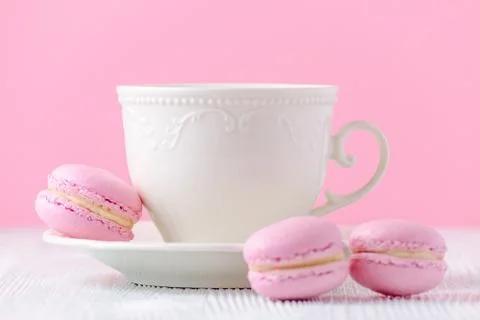 Coffee cup on pink background, macaroons Stock Photos