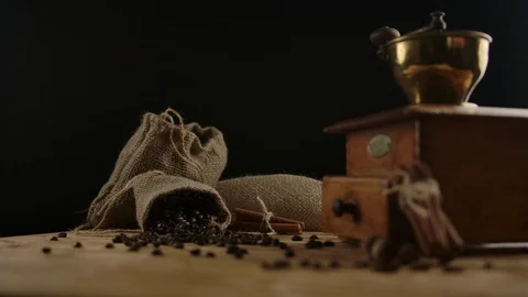 Coffee cup placed on table with beans and grinder on background. Beverage Stock Footage 129630018