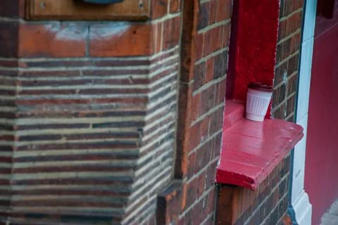 The coffee cup is placed at the window edge. Stock Photos