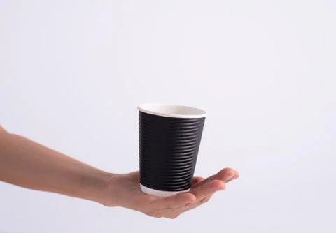 Coffee cup put on human hand,on white background Stock Photos