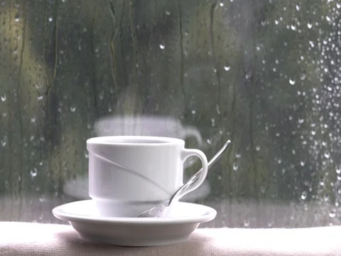 Coffee cup on a rainy day window and the good life Vidéo 76863874