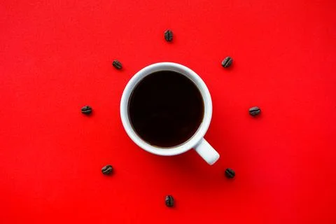 Coffee cup on red background with beans arrang as forming clock face Stock Photos